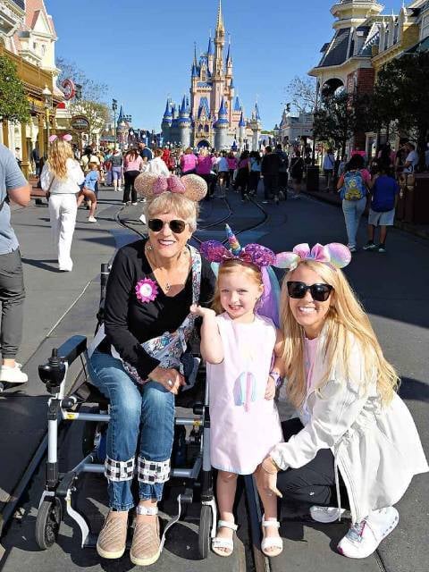 Photo of family with power chair at theme park