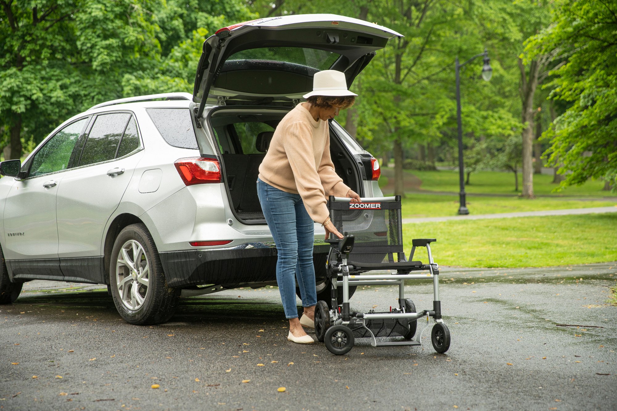 Woman loading Zoomer into SUV Woman loading Zoomer into SUV